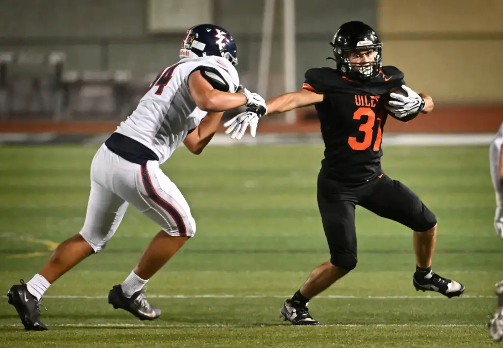 Huntington Beachâs Jacob Gonzales (31) runs with the ball as...