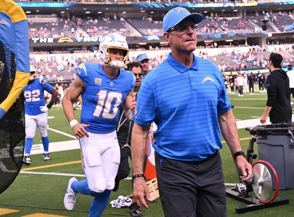 Chargers head coach Jim Harbaugh and quarterback Justin Herbert (10)...