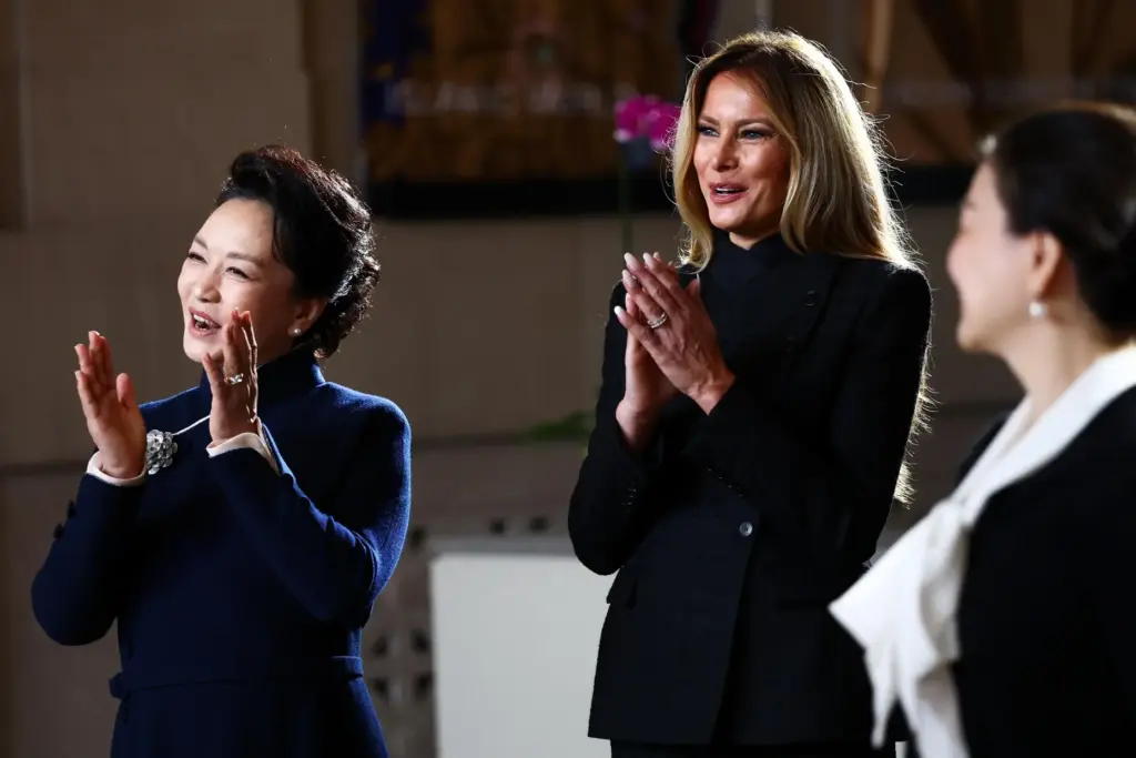 First lady of China Peng Liyuan and first lady Melania Trump clap.
