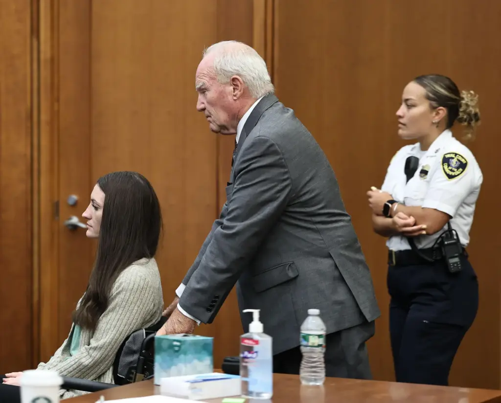 Defense attorney Kevin Reddington pushes the wheelchair of Lindsay Clancy for a sidebar.