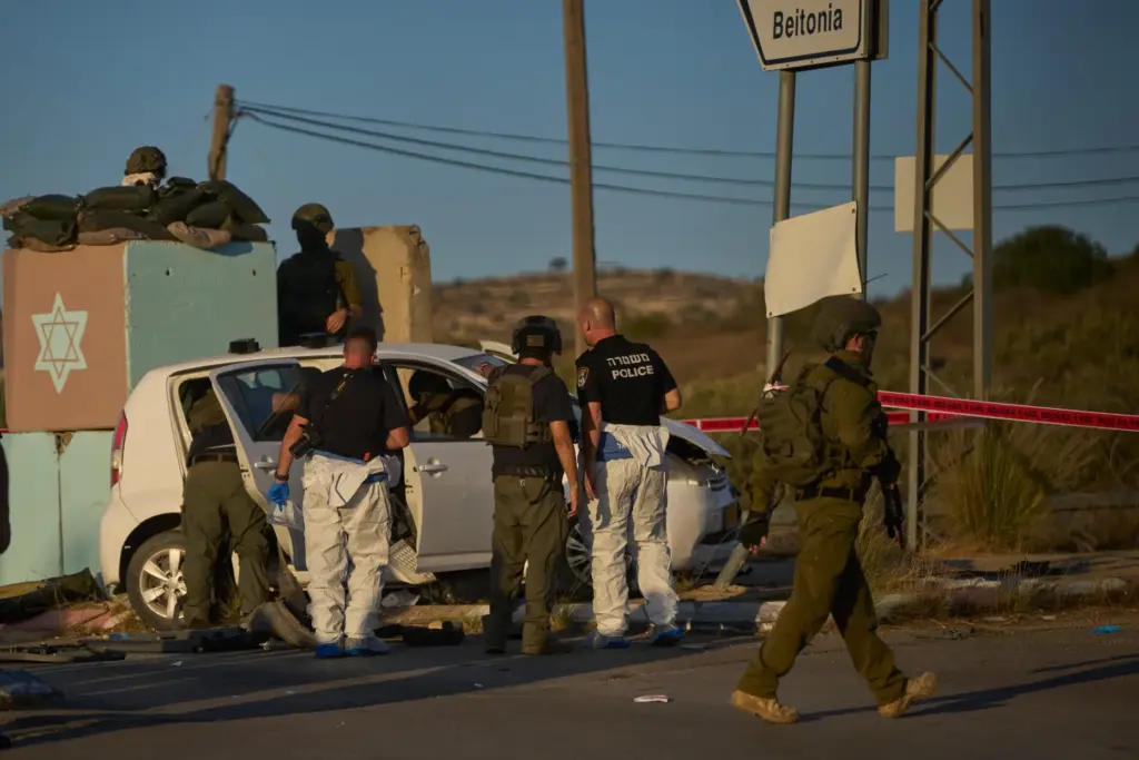 Israeli security forces inspect the scene where, according to police,...
