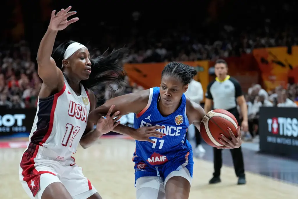 Team USA’s Jackie Young, left, defends France’s Valeriane Ayayi during...