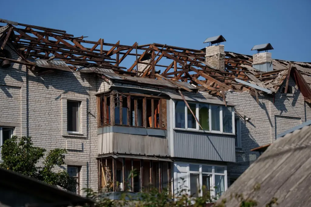 The damaged rooftop of a residential building after a Russian...