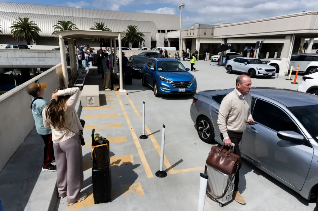 Traveleres pick up their rideshaere rides at John Wayne Airport...