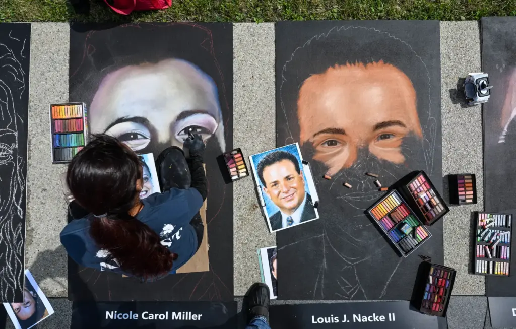 Chalk artist Jennifer Ripassa, from Eastvale, California, draws Nicole Carol...
