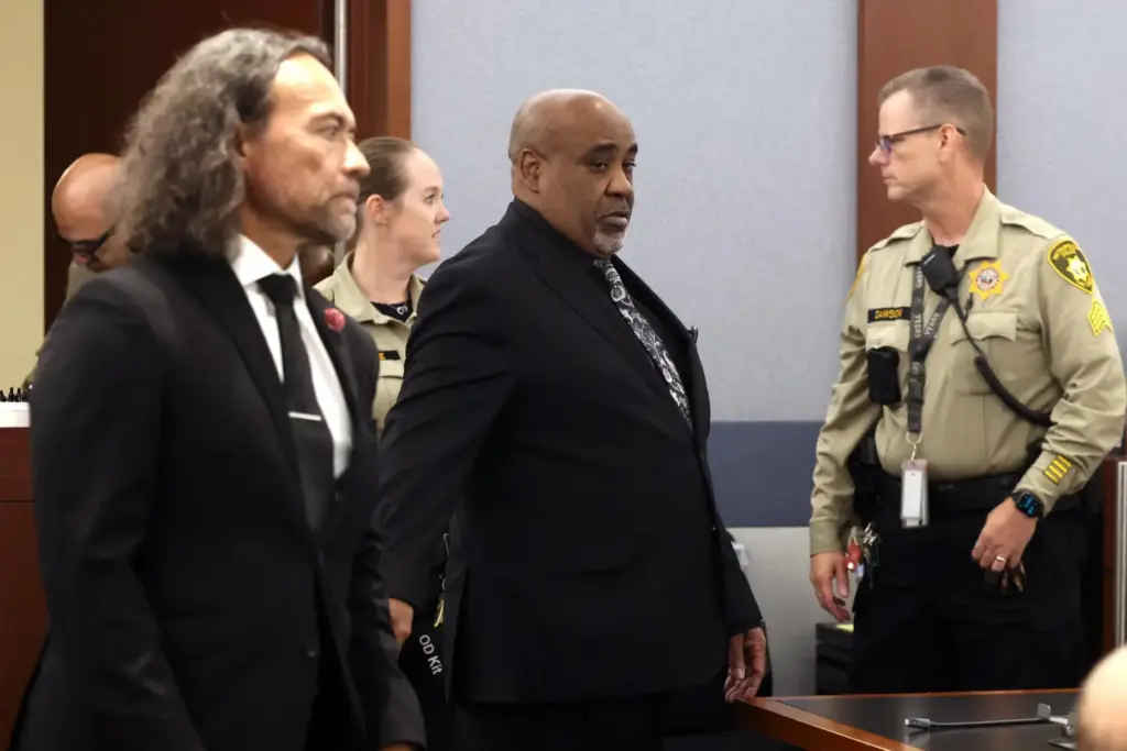Duane Davis, center, and his attorney Michael Sanft are led...