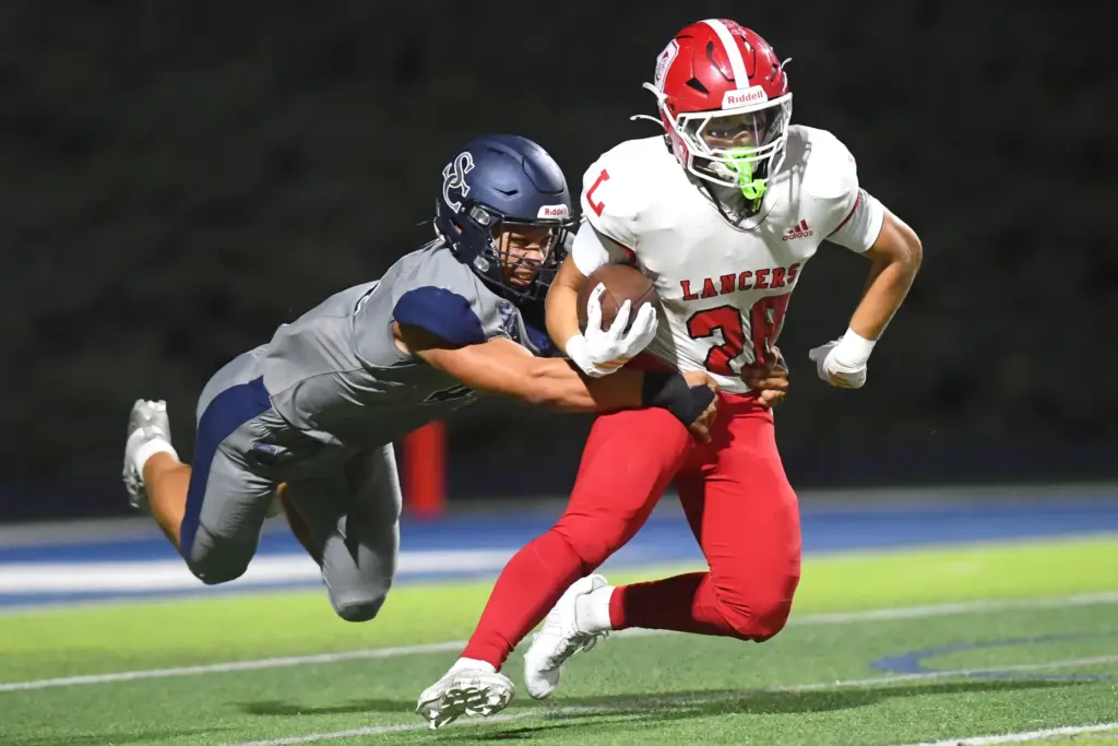 Sierra Canyonâs Eli Zamorano tries to tackle Orange Lutheranâs Ryan...
