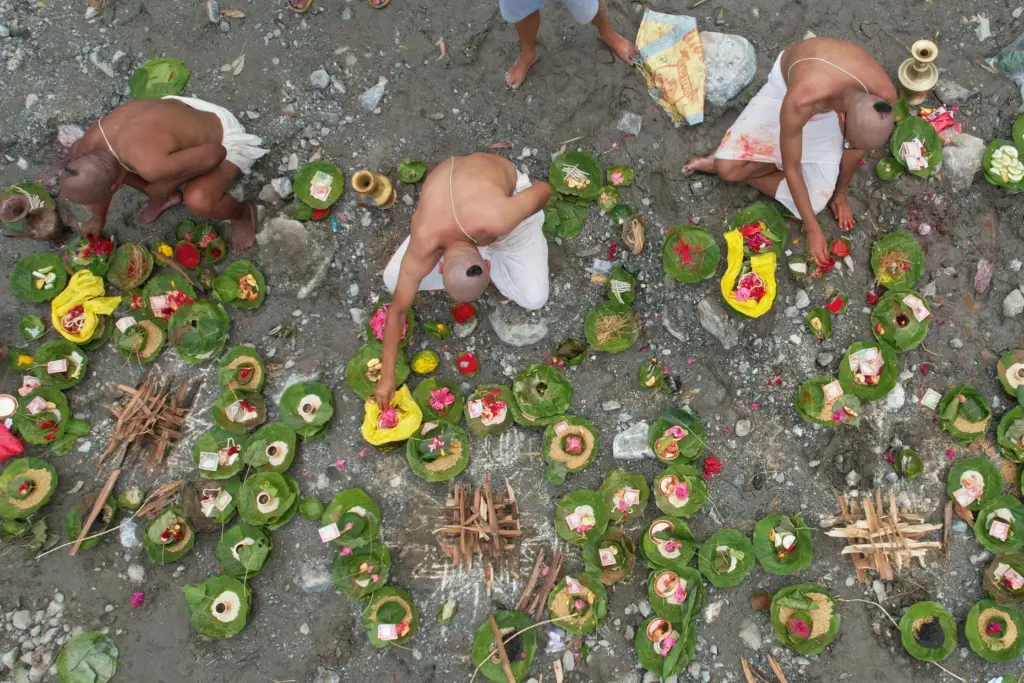 People whose relatives remain missing following flash floods perform symbolic funeral rites.
