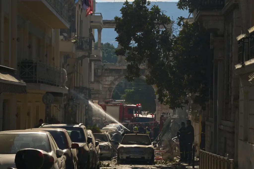 Firefighters work at the scene following a powerful blast that...