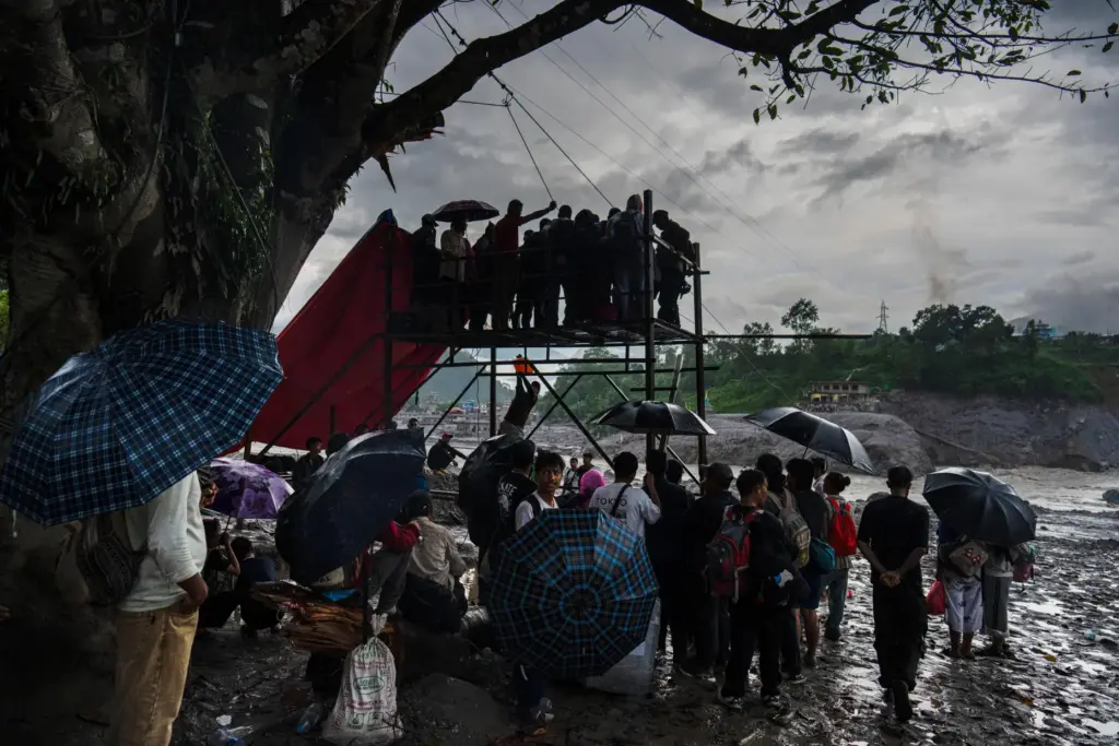 Residents wait for their turn commute across the Trishuli river.