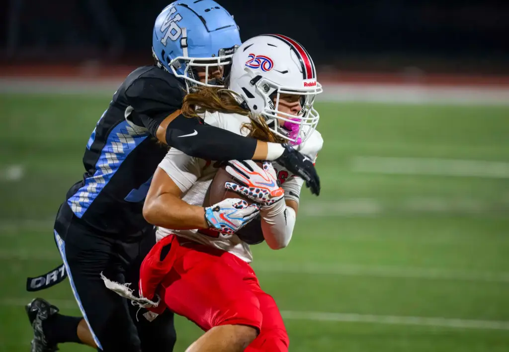Lakewood wide receiver Steve Orozco, right, is hit by Villa...