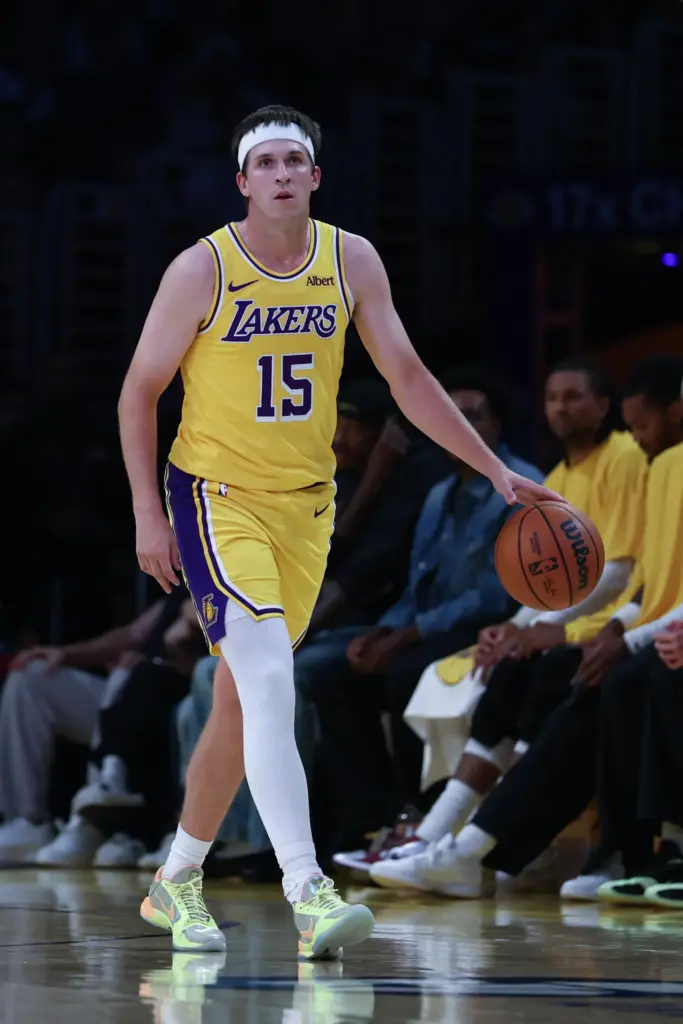 Lakers guard Austin Reaves brings the ball up the court...