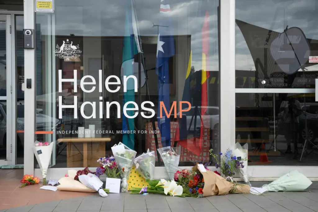 Tributes and flowers are placed outside the electoral office for Helen Haines.