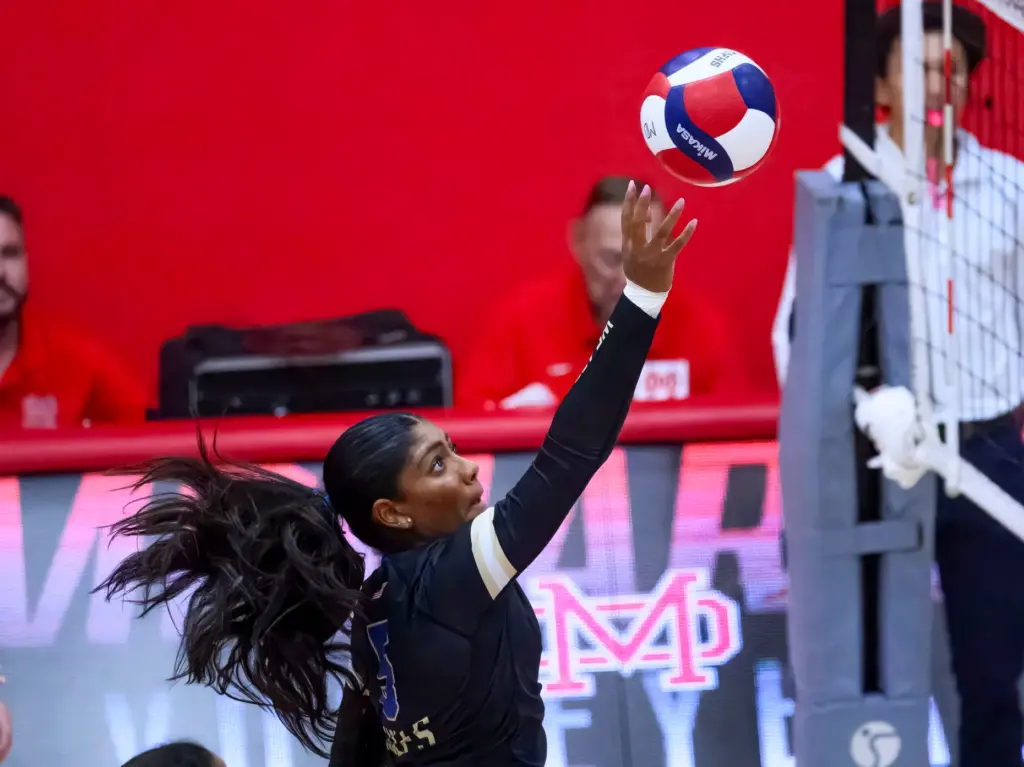 Santa Margarita’s Ella Opene taps the ball over the net...