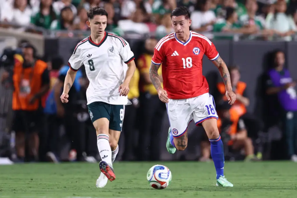 Chile midfielder Rodrigo EcheverrÃ­a, right, controls the ball while being...
