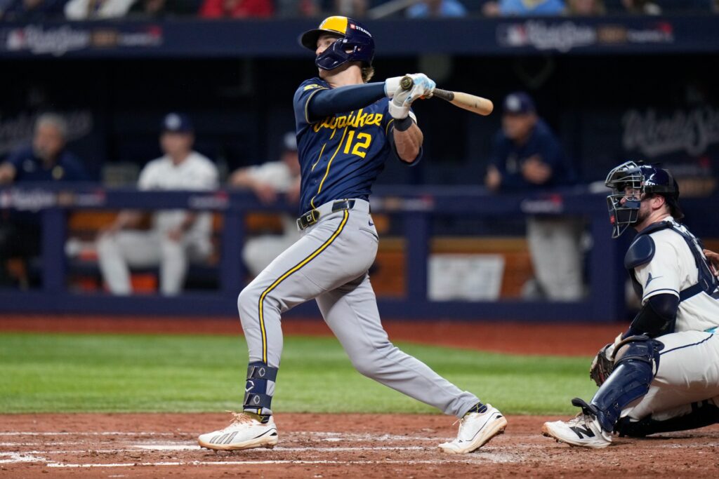 The Milwaukee Brewers’ Cooper Pratt follows through on a base...