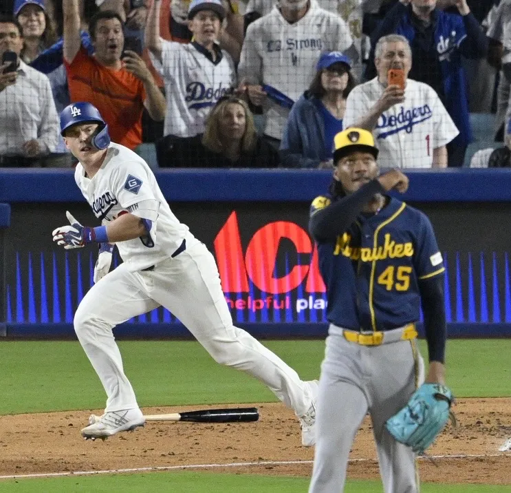 The Dodgers’ Will Smith begins to run as he watches...