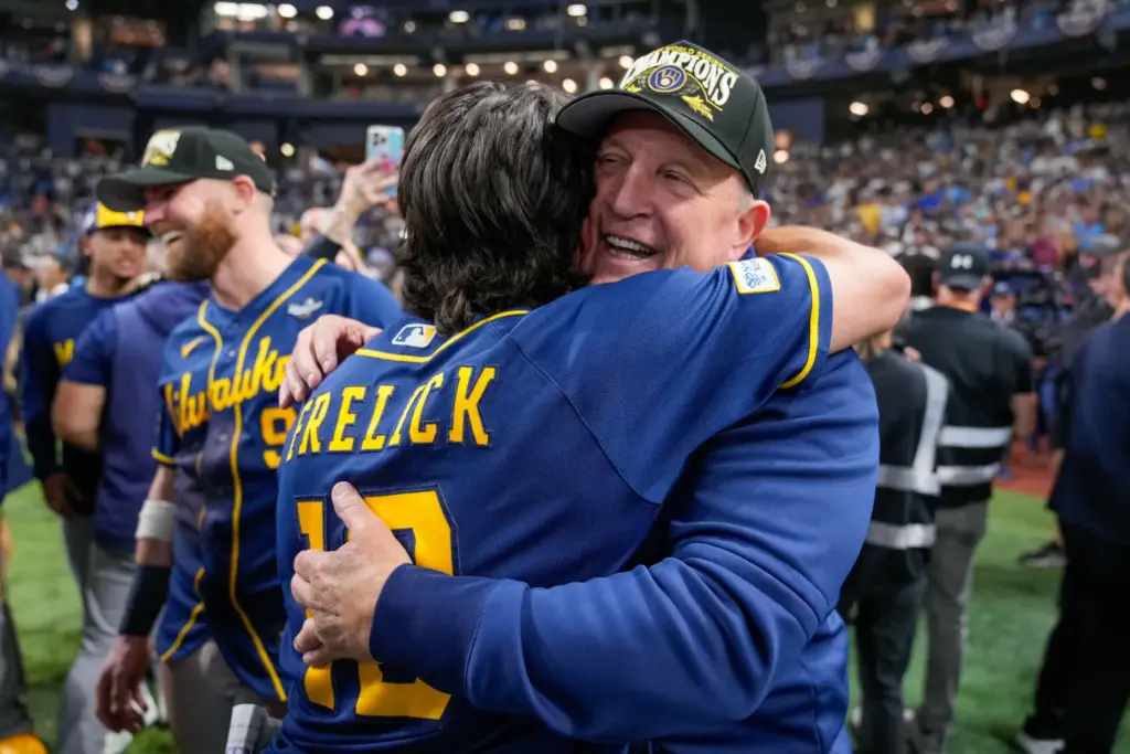 Milwaukee Brewers manager Pat Murphy hugs right fielder Sal Frelick...