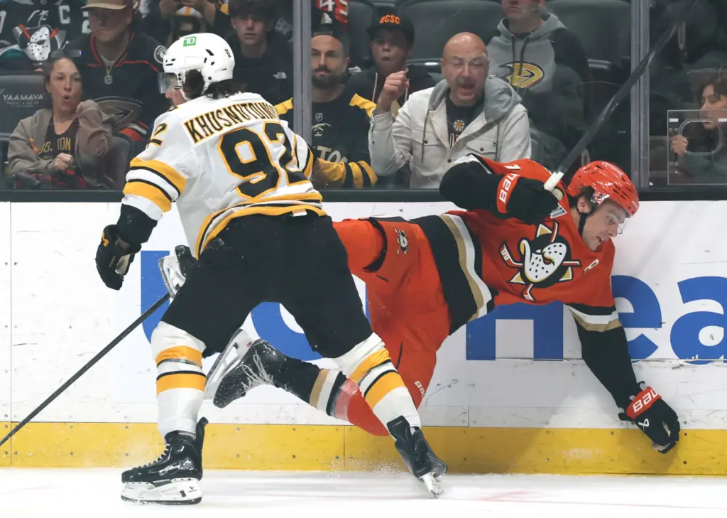 The Ducks’ Leo Carlsson, right, falls to the ice after...
