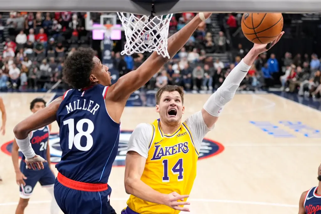 Lakers center Walker Kessler, right, shoots as Clippers forward Baba...