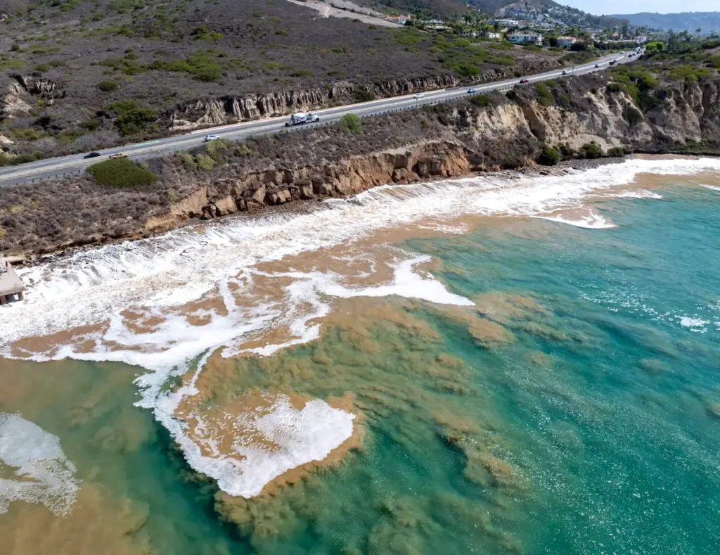 The ocean is churned up as the bluff is eroded...