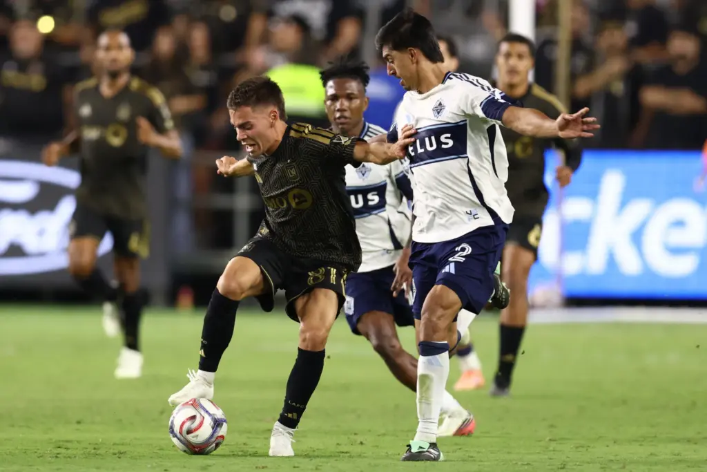 Los Angeles FC midfielder Leo Walta, left, controls the ball...