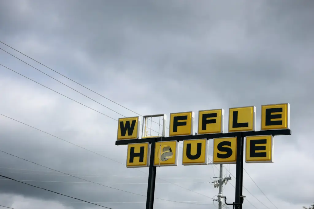 A Waffle House sign sits outside the restaurant as it...