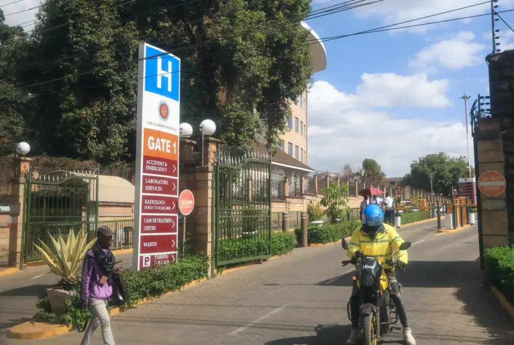 People walk in front of The Nairobi Hospital where Kenya’s...