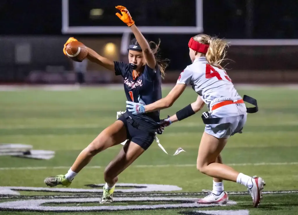 Huntington Beach running back Kyla Uno (1), left, carries the...