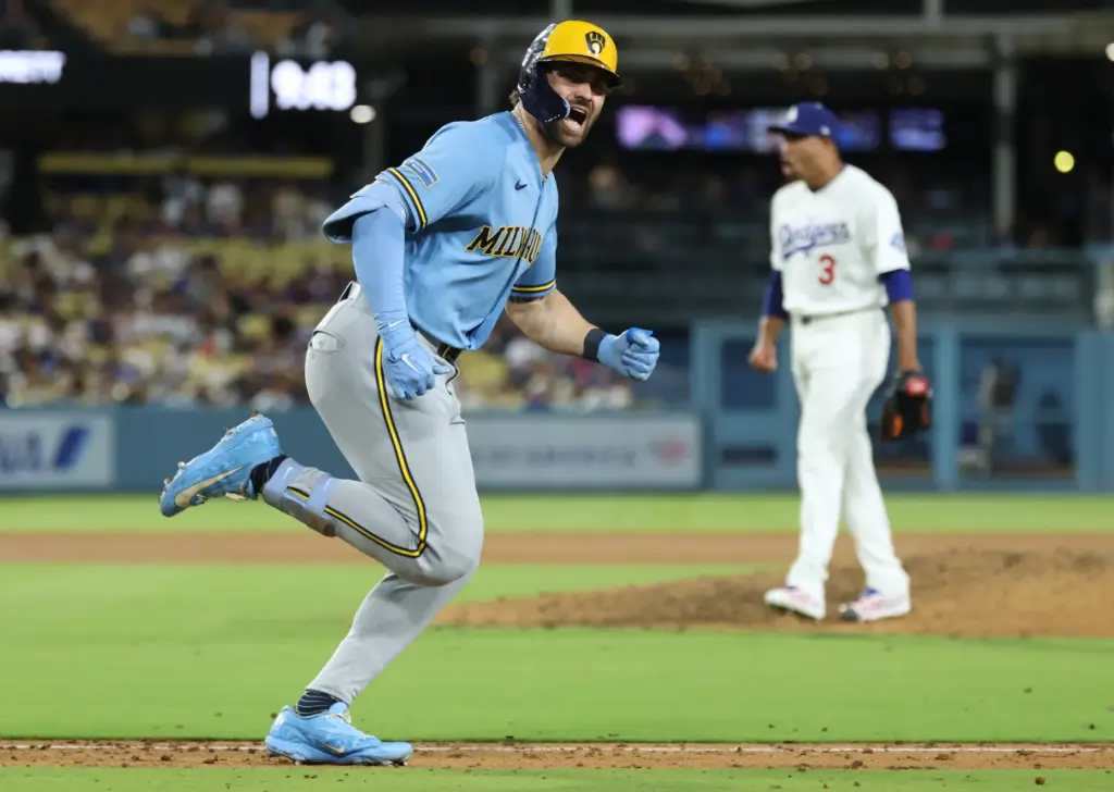 The Milwaukee Brewers’ Garrett Mitchell celebrates as he runs after...
