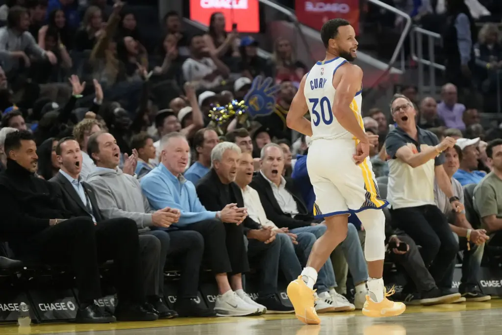 Golden State Warriors guard Steph Curry (30) reacts after scoring...