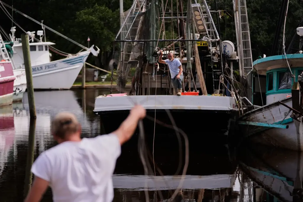 Boat owner Tony Rice, foreground, and his friend Lance Connor...