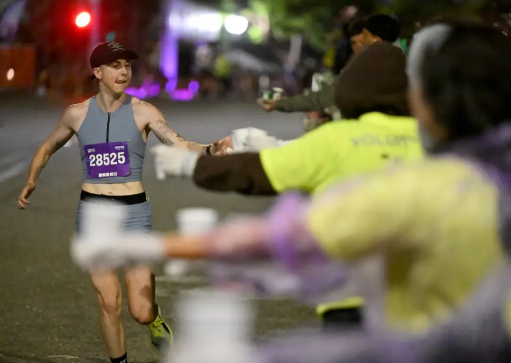 Jules Madzia grabs some water on her way to win...