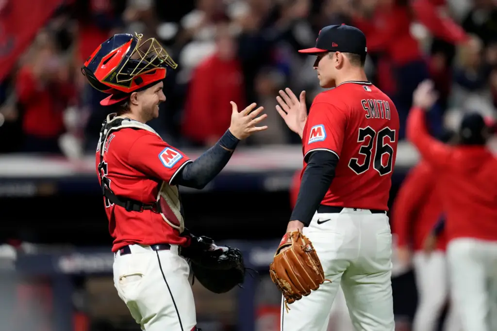 Cleveland Guardians catcher Patrick Bailey, left, celebrates with pitcher Cade...