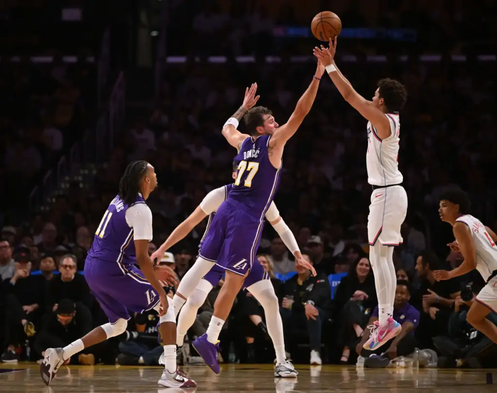 Clippers rookie guard Keaton Wagler, right, shoots as Lakers star...