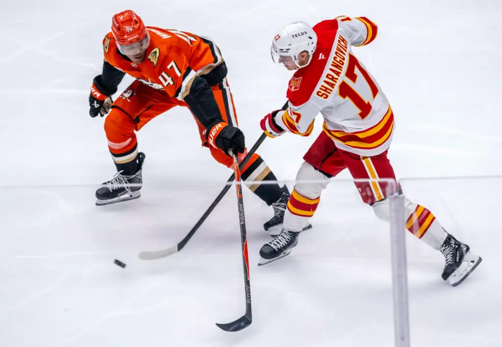 Calgary Flames center Yegor Sharangovich, right, takes a shot on...