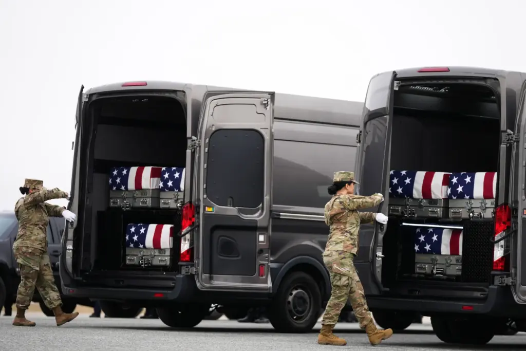 FILE – Door attendants secure the doors of the transfer...