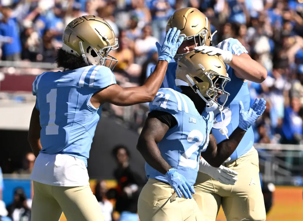 UCLA running back Jaivian Thomas (21) celebrates a rushing touchdown...