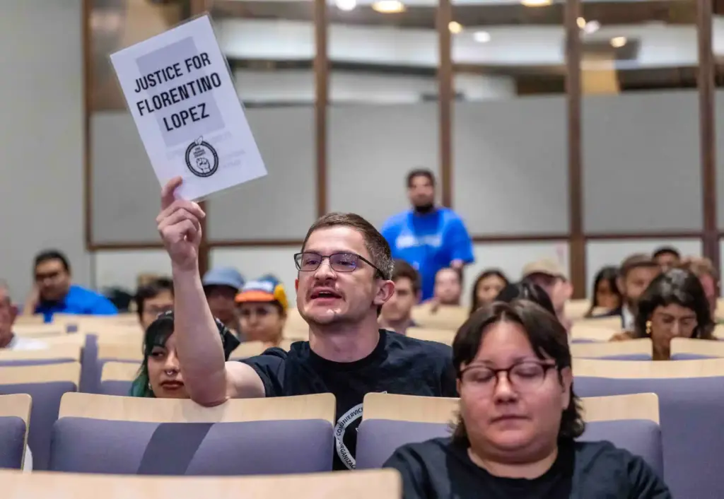 Members of the public hold up signs asking for âjustice...
