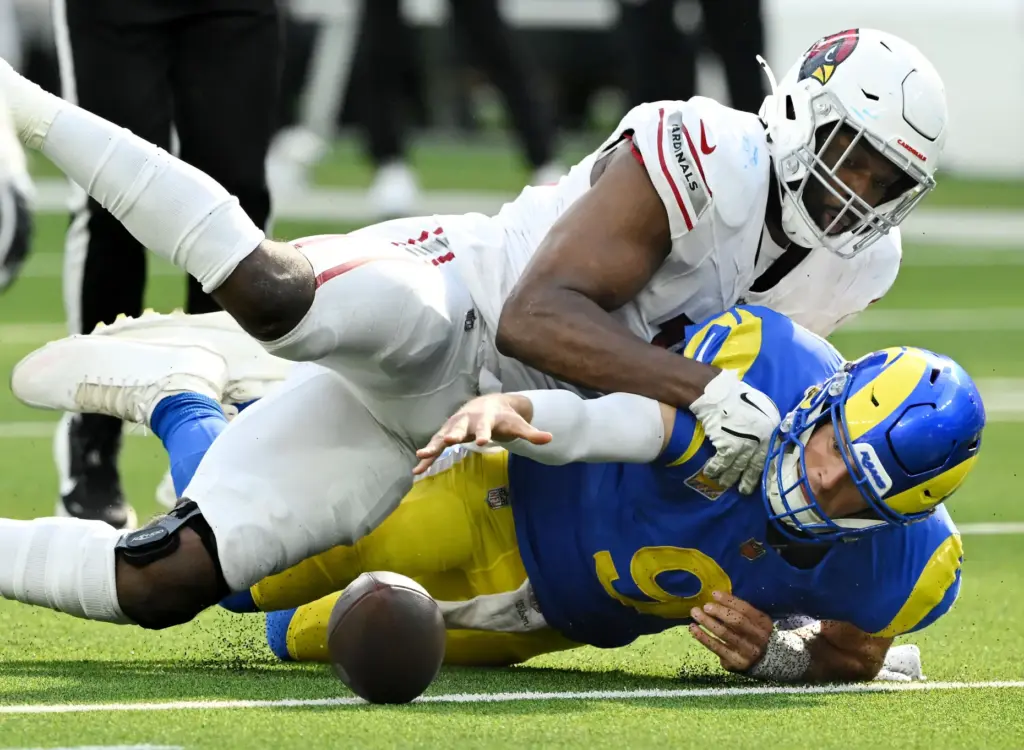 Rams quarterback Matthew Stafford (9) fumbles the ball and is...