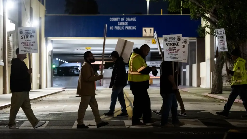 Members of Teamsters Local 952 picket in front the county...