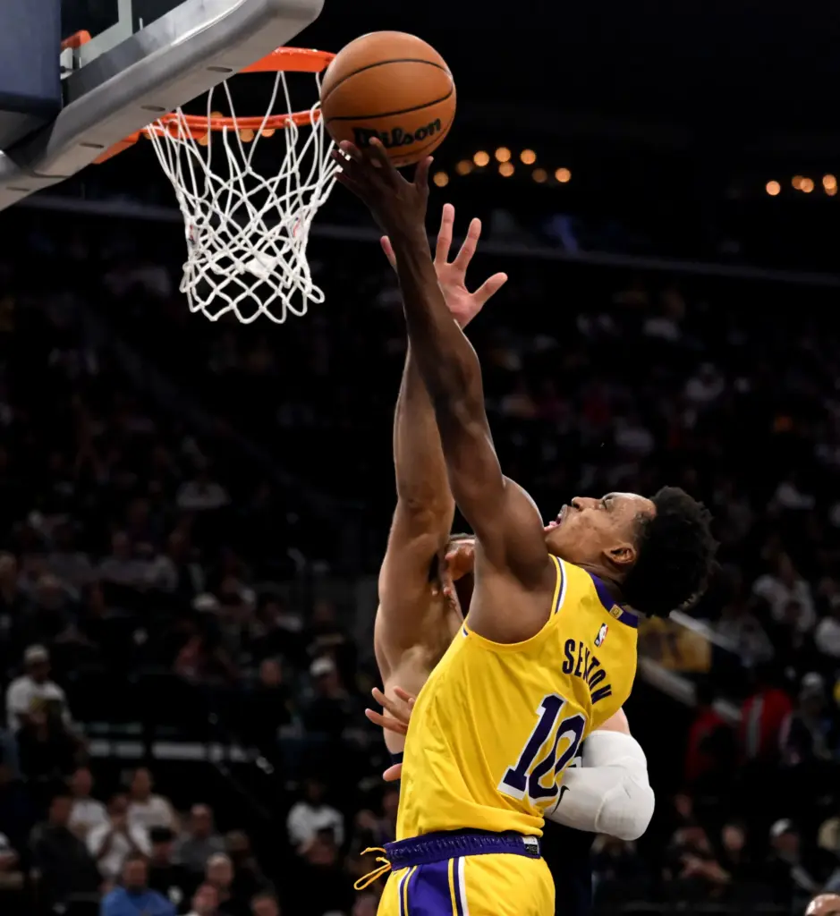 Lakers guard Collin Sexton gets to the basket for a...