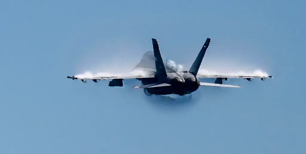 A United States Navy F/A-18 Rhino flies during the Pacific...