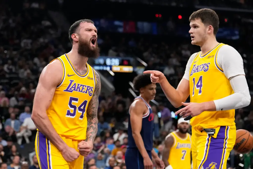 Lakers forward Sandro Mamukelashvili, left, celebrates with center Walker Kessler...