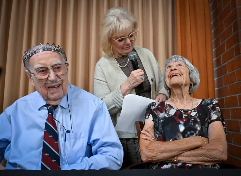 Ernie Maunders, 101, left, laughs at the questions that Gina...
