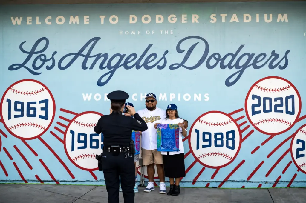 Dodgers fans pose for a photo in front of a...