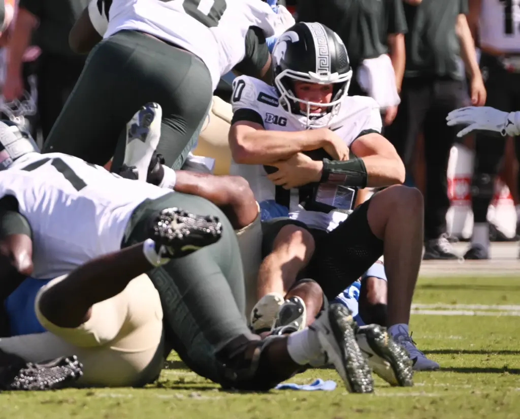 UCLA linebacker Jalen Woods (9) sacks Michigan State quarterback Kayd...