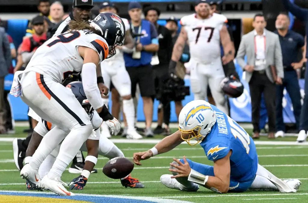Chargers quarterback Justin Herbert fumbles on the last play of...