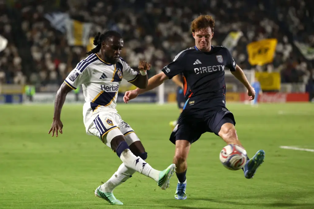 Los Angeles Galaxy forward Joseph Paintsil, left, kicks the ball...