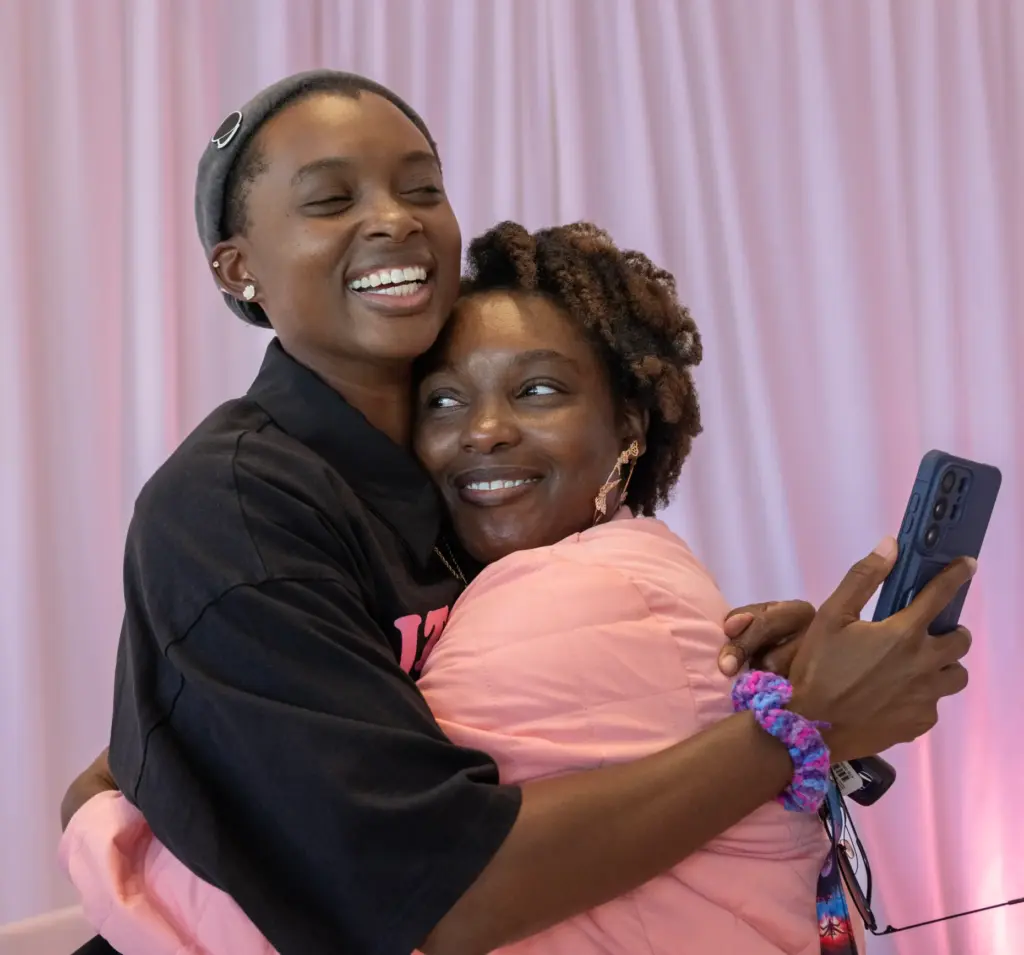 Janay Bruner-Wilson, left, hugs her sister, Sade Wilson, one of...